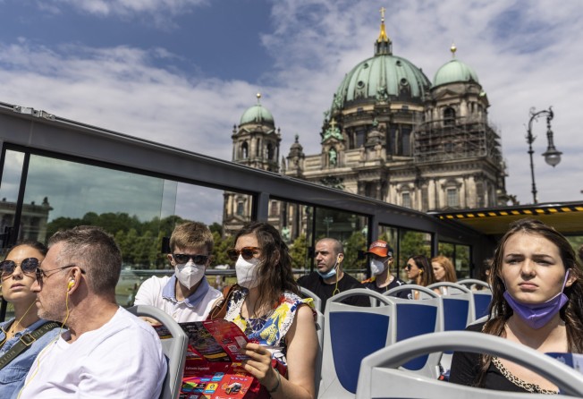 Passengers ride a double-decker tourist bus past the Berlin Cathedral. Photo: Getty Images