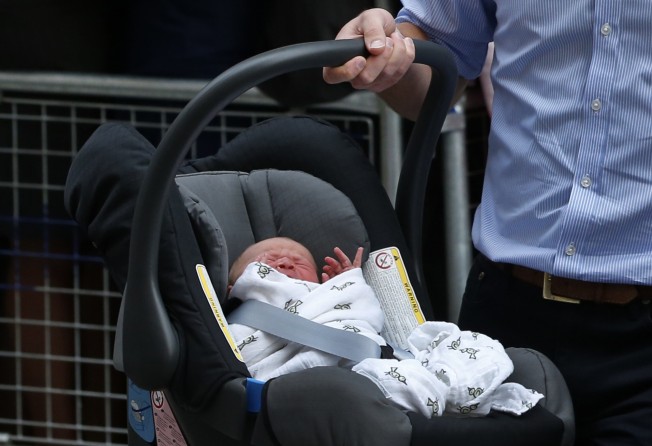 Britain’s Prince William carries his son, Prince George of Cambridge, into a car outside St. Mary’s Hospital in London, on July 2013. Photo: AP Photo
