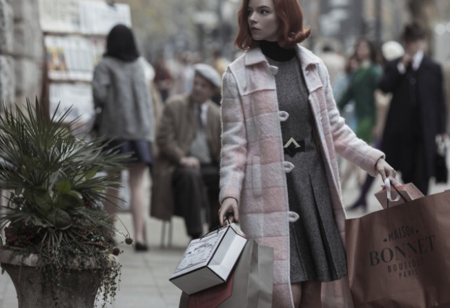 Anya Taylor-Joy wearing the Nikki coat in pink and white in an episode of The Queen’s Gambit. Photo: Netflix