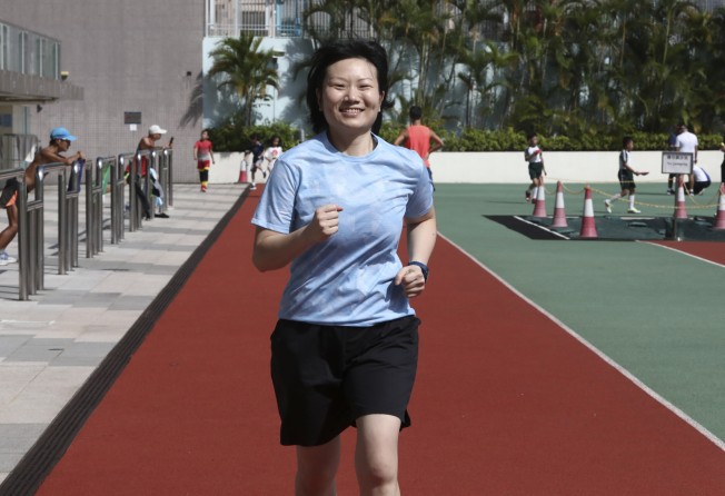 Breast cancer survivor Chan goes for a jog at Tsing Yi Sports Ground in the New Territories. Photo: Jonathan Wong