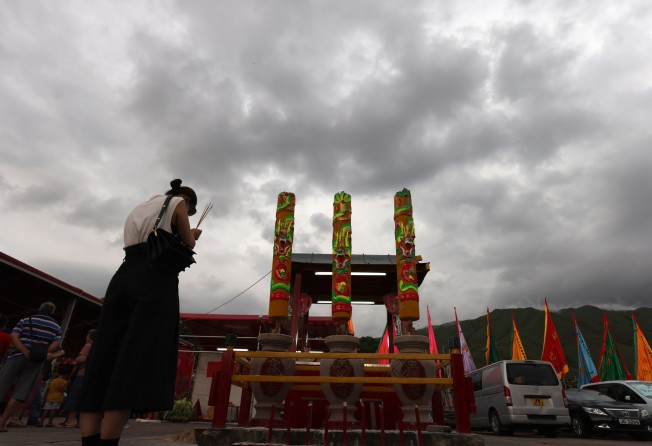 A woman performs a ritual for the Hungry Ghost Festival in Tai Kong Po Tsuen. Photo: Nora Tam