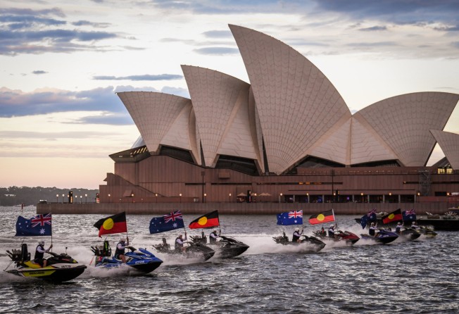 Jet skis displaying Australian and Aboriginal flags in front of the Sydney Opera House during an Australia Day show on January 26 this year. Photo: Getty Images