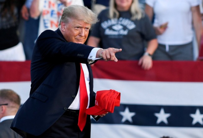Former US president Donald Trump holds MAGA hats during his first post-presidency campaign rally at the Lorain County Fairgrounds in Wellington, Ohio, US, in June 2021. Photo: Reuters