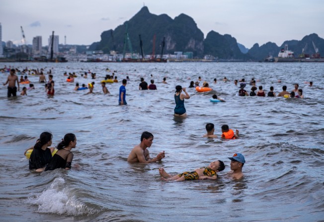 Tourists enjoy a swim at Bai Chay beach in Quang Ninh province. Vietnam plans to restart international commercial flights with 15 countries from January next year. Photo: Getty Images