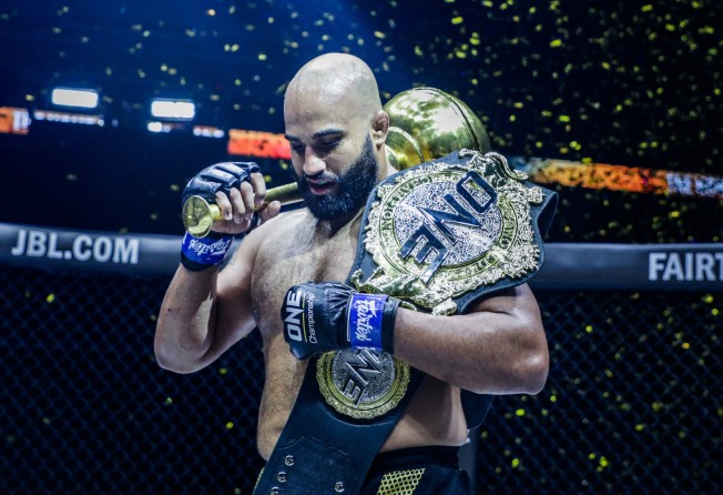 Arjan Bhullar celebrates with the ONE heavyweight world title after beating Brandon Vera.