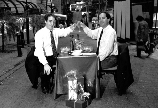 Feldman (left), then general manager of Graffiti restaurant, shares a toast with Phil Rosenberg, managing director of Great Wall Graphics, in Lan Kwai Fong, Hong Kong, in 1991. Photo: SCMP