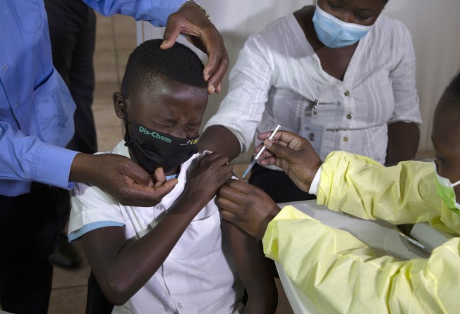 A child winces as he receives his Pfizer vaccine against Covid-19 in Diepsloot Township near Johannesburg in October. Photo: AP