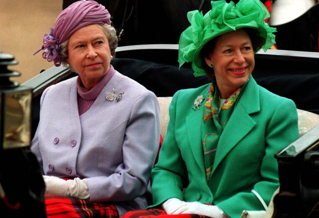 Queen Elizabeth and her younger sister, Princess Margaret, arrive by carriage at Horseguards Parade, London, in 1993 file photo. Photo: AP Photo/PA