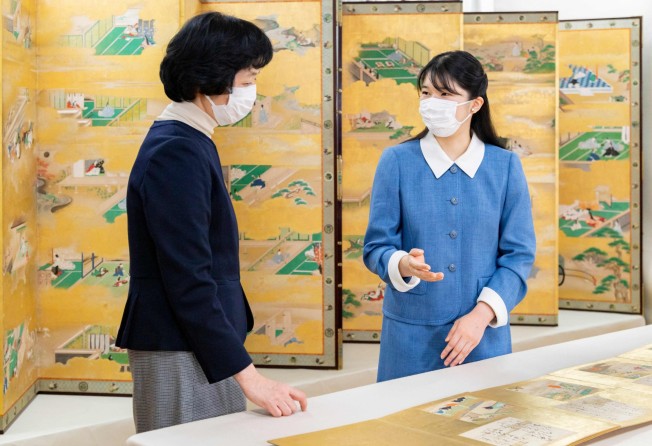 Japan’s Princess Aiko, right, speaks with a curator at the Museum of the Imperial Collections in Tokyo last month, ahead of her 20th birthday. Photo by Imperial Household Agency Handout via AFP