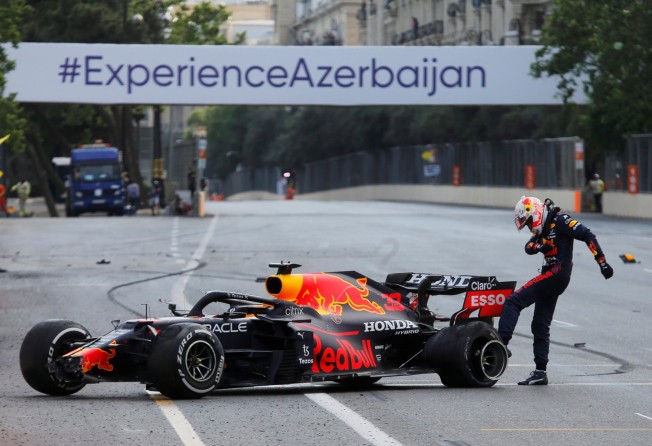 Max Verstappen kicks the wheel of his car after crashing out of the Azerbaijan Grand Prix. Photo: Reuters