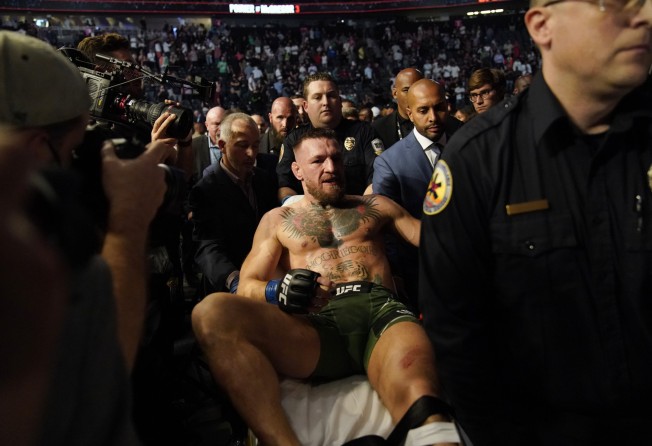 Conor McGregor is carried off on a stretcher after losing to Dustin Poirier in their UFC 264 lightweight bout. Photo: AP