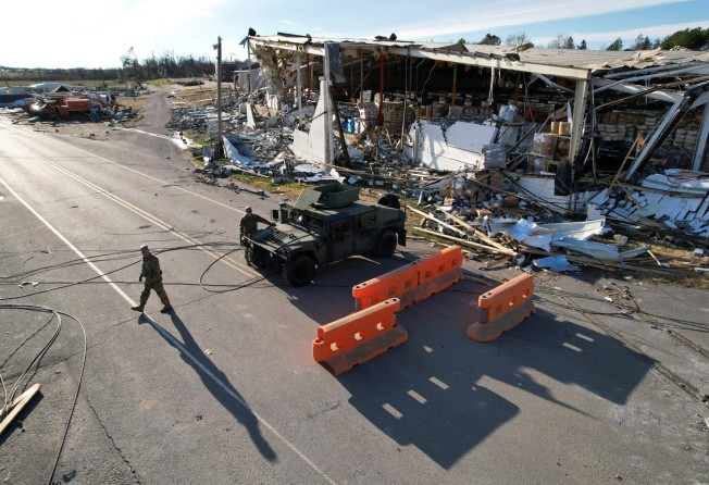 National guardsmen block the road leading to a Kentucky candle factory where many workers died when tornadoes ripped through several US states. Photo: Reuters