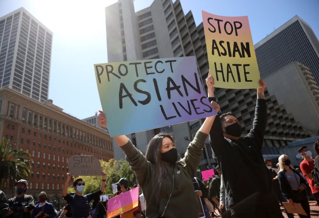 Protesters hold up signs during a rally to show solidarity with Asian-Americans in San Francisco, California, on March 26. Photo: Getty Images via AFP