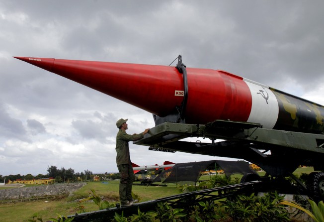 A soldier pauses to look at the outer casing of an old empty Soviet missile on an exhibit as he works to paint it at the Morro Cabana military complex, which is open to tourists in Havana, Cuba, on October 13, 2012. Even at the height of the Cold War, the US and Soviet Union managed to establish nuclear safeguards, having experienced the harrowing weeks of the Cuban missile crisis, when the world came perilously close to catastrophe. Photo: AP
