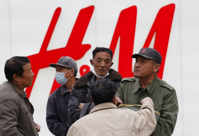 China has stepped up pressure on foreign shoe and clothing brands to reject reports of abuses in Xinjiang. Photo: AP/Ng Han Guan
