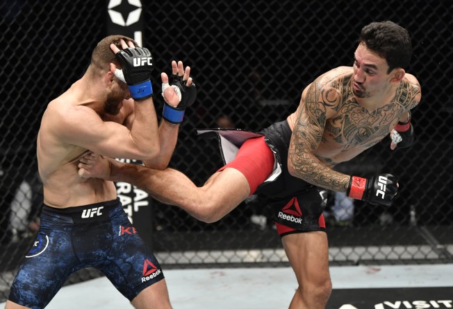 Max Holloway kicks Calvin Kattar in a featherweight bout during the UFC Fight Night event at Etihad Arena on UFC Fight Island. Photo: Zuffa LLC