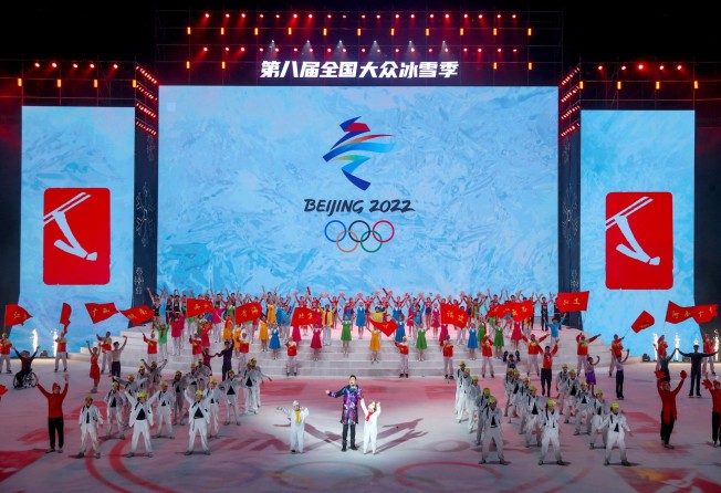 Actors perform before the emblem of the Beijing 2022 Winter Olympics at a launch ceremony for the national ice and snow season in Wuhan. Photo: Reuters.
