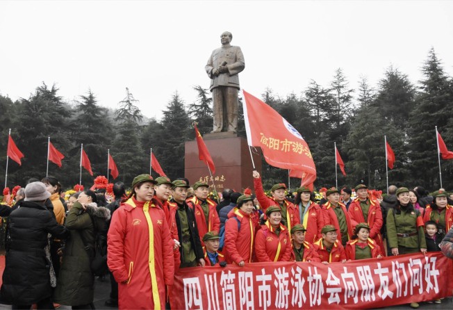 People pose in front of a statue of Communist China's founder Mao Zedong in Shaoshan, Hunan province, on December 26, 2018. This year’s gathering to celebrate the anniversary of his birth was smaller than usual. Photo: Kyodo News Stills via Getty Images
