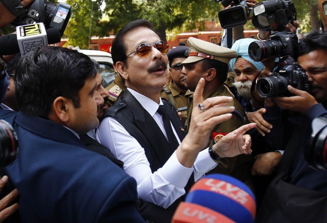 Sahara Group Chairman Subrata Roy (centre) arrives at the Supreme Court in New Delhi after being accused of cheating his investors, among other crimes, in March 2014. Photo: Reuters 