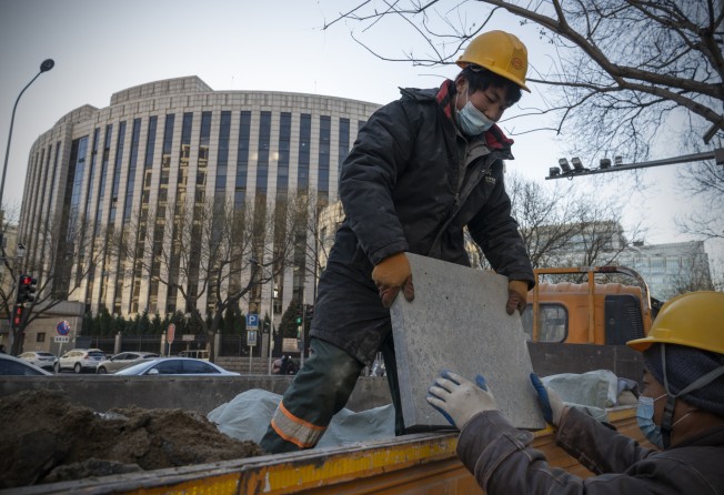 Workers unload a truck in front of the People’s Bank of China in Beijing on December 13. Foreign investment has soared in many of Asia’s bond markets this year. Photo: Bloomberg