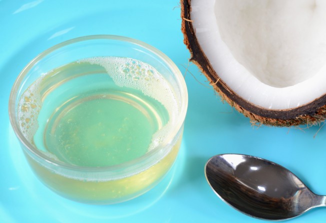 Apply coconut oil to your scalp once a month and leave it on for 20 minutes. Photo: Getty Images