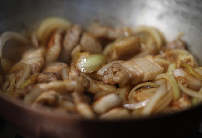 Let the ingredients simmer until the pork is done. Photo: Jonathan Wong