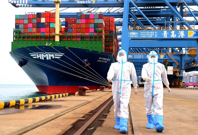 China immigration officers wearing protective clothing patrol a container port in Qingdao on November 7, 2021. Photo: AP