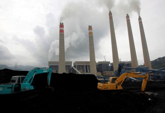 Excavators pile coal in a storage area in an Indonesian power plant in Suralaya. File photo
