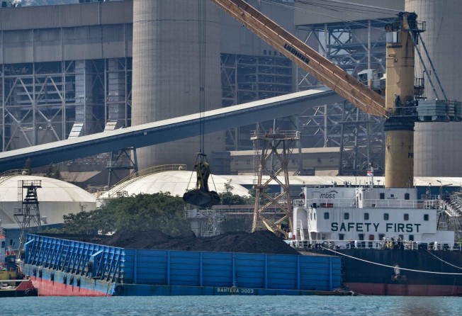 Coal is unloaded from a barge at the Suralaya coal power plant in Cilegon, Indonesia. Photo: AFP
