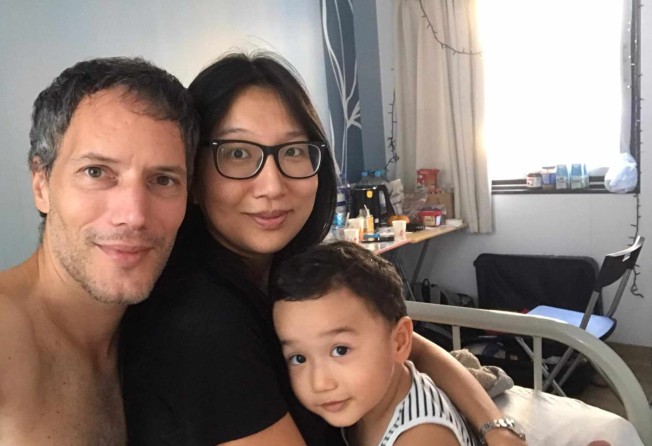 Oliver Nowak with his wife Wai Lau and son Leo inside their room at Penny’s Bay in October 2020. Photo: Olivier Nowak