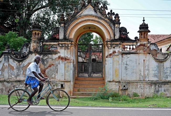 A cyclist passes a dilapidated mansion in Kanadukathan town in India’s Tamil Nadu state. Photo: AFP