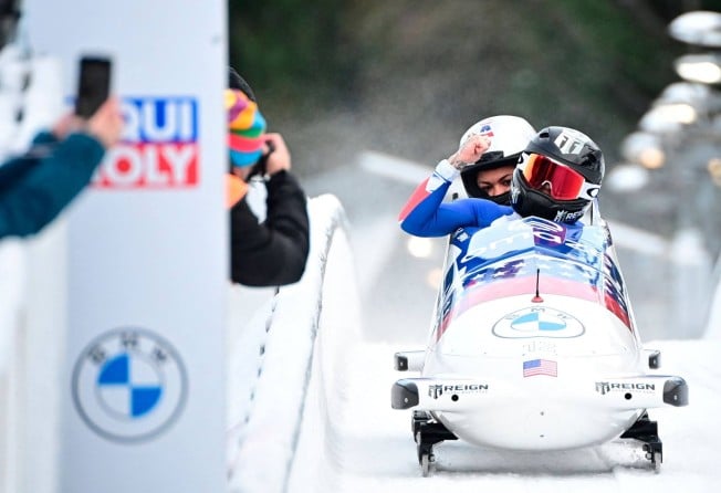 Kaillie Humphries (front) and Kaysha Love of the US react after winning the two-woman bobsleigh event at the Skeleton and Bobsleigh World Cup in Altenberg, in December 2021. Photo: AFP