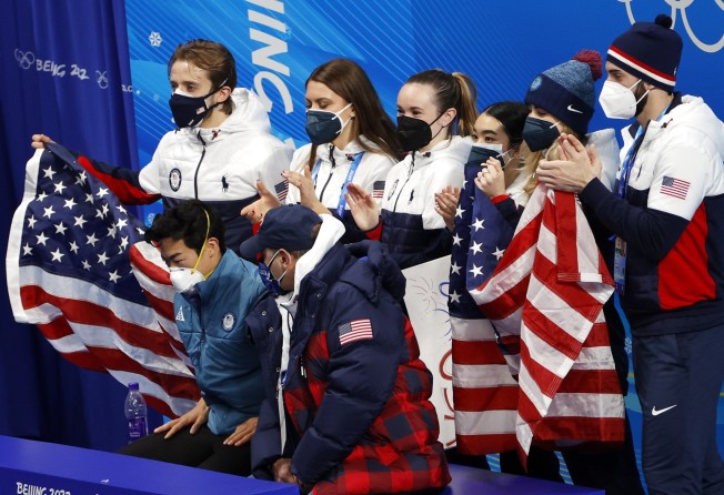 The US team applaud their teammate Nathan Chen (seated left) after he took the lead in the men’s singles short programme of the team event. Photo: EPA-EFE