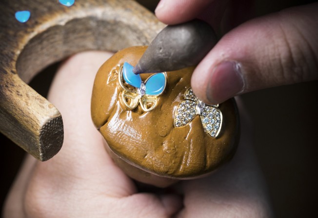 Positioning the turquoise on a Two Butterfly collection piece.