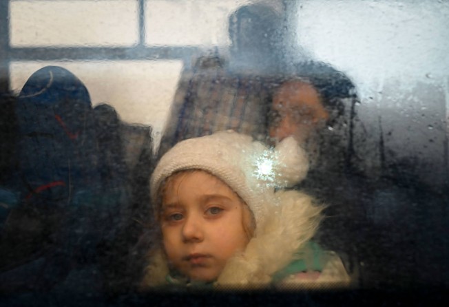 A girl fleeing the conflict in Ukraine looks on from inside of a bus heading to the Moldovan capital Chisinau. Photo: AFP