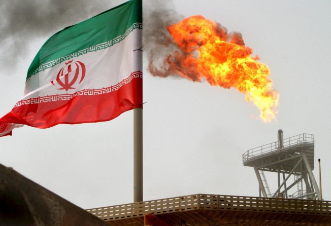 Agas flare on an oil production platform in the Soroush oilfields is seen alongside an Iranian flag in the Gulf in July 2005. Photo: Reuters