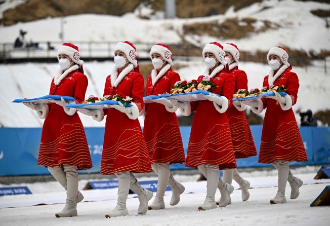 Hostesses bring medals for the open relay para cross-country skiing event on Sunday at the Zhangjiakou National Biathlon Centre. Photo: AFP