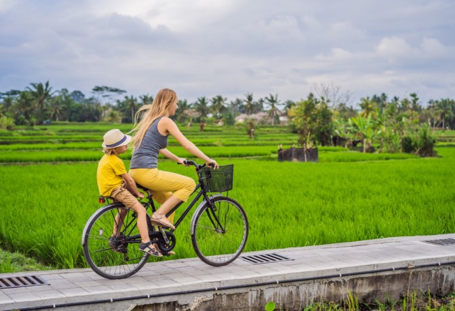 Cycling through the rice fields is popular in Ubud, Bali, Indonesia. Photo: Shutterstock