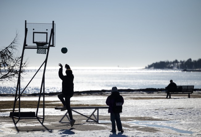 People play basketball in Finland, the world’s happiest place. Photo: Xinhua