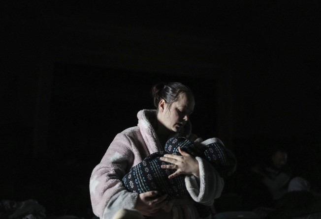A woman holds a baby in a bomb shelter in Mariupol, Ukraine, this month. Photo: AP