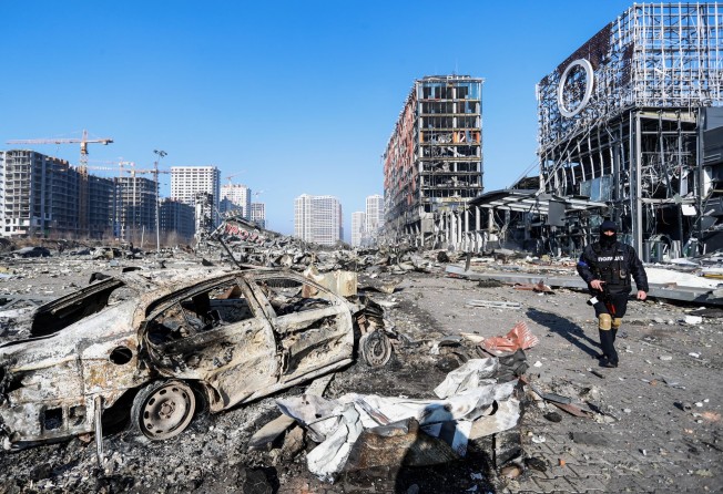 A police officer walks near the wreckage of a damaged shopping centre in Kyiv, Ukraine on Monday after a Russian air strike. Photo: dpa