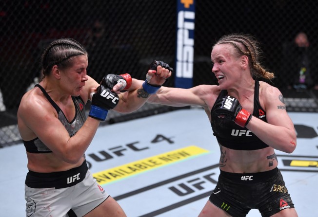 Valentina Shevchenko (right) punches Brazil’s Jennifer Maia in their women’s flyweight championship bout at UFC 255. Photo: Zuffa LLC