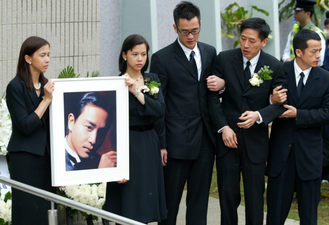 Cousins of Hong Kong actor Leslie Cheung and his long time companion Daffy Tong Hok-Tak (second from the right) attend Cheung’s funeral in Hong Kong, in 2003. Photo: Reuters