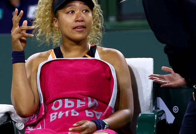 Naomi Osaka speaks with WTA supervisor Clare Wood after play was disrupted by a shout from the crowd during her straight sets defeat against Veronika Kudermetova. Photo: AFP