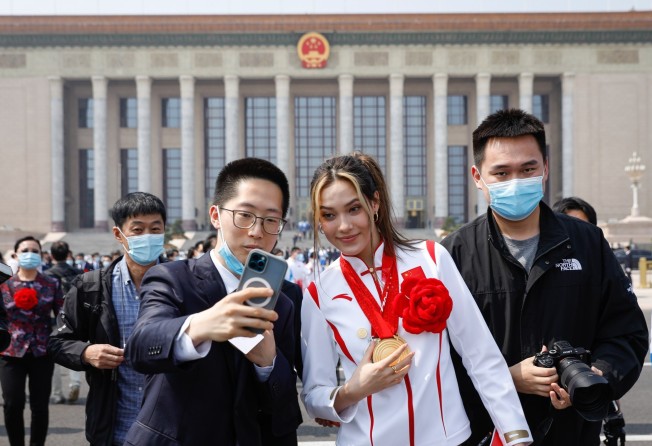 Eileen Gu poses for a selfie outside the Great Hall of the People in Beijing. Photo: EPA-EFE