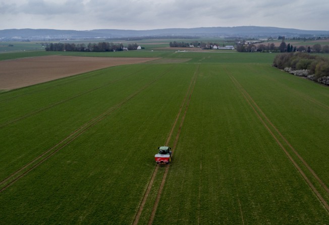 A farmer fertilises a field on the outskirts of Frankfurt, Germany. Russia’s war in Ukraine has pushed up fertiliser prices that were already high, made scarce supplies rarer still and squeezed farmers. Photo: AP