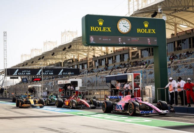 Racing cars line up at the exit of the pit lane during a practice session. Photo: Rolex