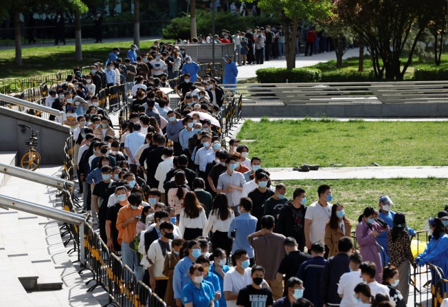 People lined up outside a nucleic acid testing site during a mass testing exercise in Beijing’s Haidian district on April 26, 2022. Photo: Reuters