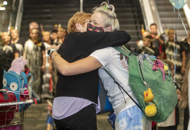 Passengers arriving from Sydney are greeted by family members at Wellington Airport in New Zealand earlier this month. Photo: Mark Mitchell/New Zealand Herald
