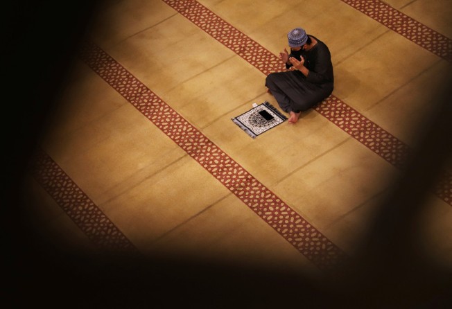 A man prays at a mosque in Singapore last month. Capacity limits were imposed on the city state’s religious venues amid the pandemic. Photo: Reuters